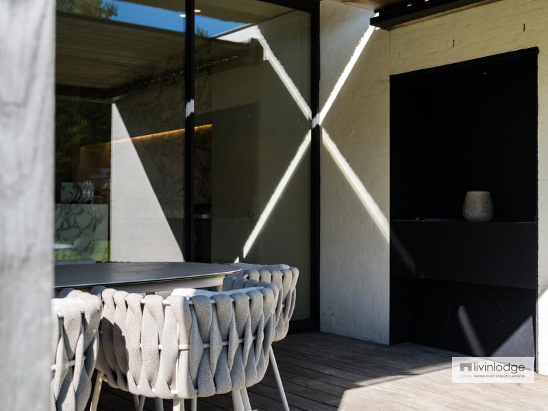 When closed, the louvered roof offers shade and shelter from the elements