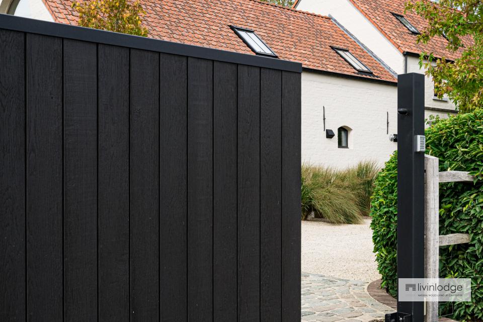 Elegant sliding gate in black wood