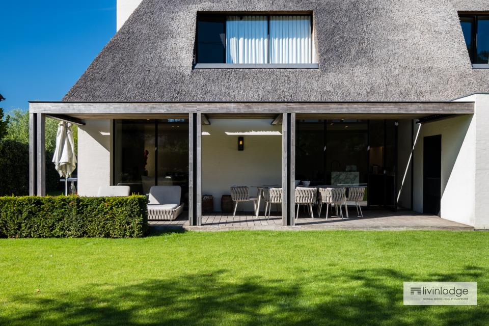 A stylish pergola with a louvered roof on an extension offers comfort all year round